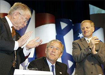 F_US President George W. Bush (C), is welcomed by board member Robert Asher(L) and Executive Director Howard Kohr(R) as he waits to addresses the American Israel Public Affairs Committee(AIPAC) 18 May 2004, at the Washington Convention Center in Washington,DC saying that renewed violence in the Gaza Strip was "troubling", while reaffirming his belief that Israel has a right to target extremists. AFP Photo/Paul J. Richards