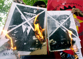 Indonesian students burn pictures of presidential candidates from the Golkar party, Wiranto (L) and Democrat party, Yudhoyono (R) during a protest in Jakarta, 04 May 2004. Scores of students held a demonstration against militarism.