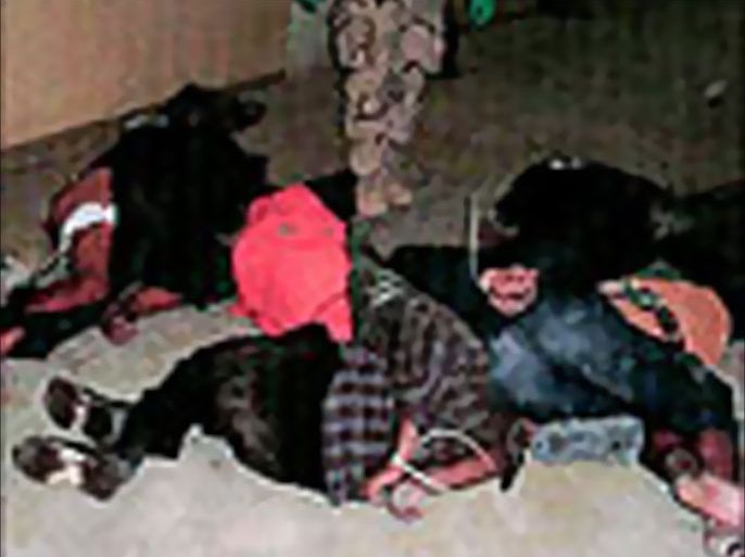 F_This undated image obtained 09 May, 2004 shows hooded and bound Iraqi prisoners lying on the floor at Abu Ghraib prison ner Baghdad.