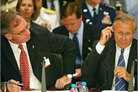 British Defence Secretary Geoffrey Hoon (L) looks at his U.S. counterpart Donald Rumsfeld during a NATO foreign ministers meeting in Istanbul, June 27, 2004. NATO defence ministers gathered on Sunday to set "usability" targets for their armed forces, many of which are still better placed to fight the now-defunct USSR than new threats on far-flung battlefields. REUTERS/Jeff J Mitchell