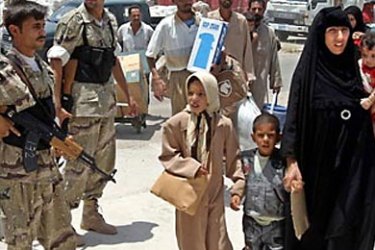 r: Iraqi national guardsmen provide security for refugees arriving at al-Maaqal port in southern Iraq July 22, 2004. About 450 Iraqi refugees returned to their country on Wednesday after living 13 years in Iran as they ran away from the regime of the ousted Iraqi leader Saddam Hussein.