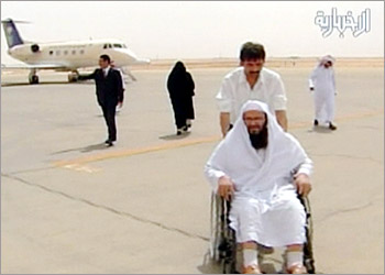 A television grab shows suspected al Qaeda militant Khaled al-Harbi (R) arriving in Saudi Arabia on an unknown date. The suspected Saudi al Qaeda militant, who had appeared in a videotape with Osama bin Laden, was flown back Saudi Arabia from Iran after he surrendered under a government amnesty, state television said July 13, 2004. Khaled al-Harbi, also known as Abu Suleiman al-Makki, had been on the Iranian-Afghan border and had contacted Saudi Arabia's embassy in Tehran in response to the amnesty. NO SALES - EDITORIAL USE ONLY - NO ACCESS SAUDI ARABIA - REUTERS/Al Ekhbariyah