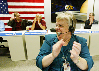 Cassini-Huygens flight director Julie Webster reacts as the Cassini spacecraft successfully fires its retrorockets to enter the orbit of Saturn, 30 June 2004 at mission control at NASA's Jet Propulsion Laboratory in Pasadena, California. After a nearly seven-year, 2.2 billion-mile (3.5 billion-km) journey, the Cassini spacecraft with the Huygens probe executed the critical maneuver to slip through Saturn's rings and begin the burn to eventually park itself in orbit around the planet for it's four year mission to examine the planet and to land the Huyens probe on Titan, Saturns largest moon. AFP PHOTO / POOL / FRANCINE ORR