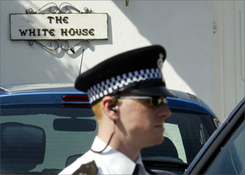A policeman stands guard outside a home on Little Bushey Road in Bushey, Northwest London, 04 August 2004 after one man was arrested late 03 August in suspected terrorism charges. Police are holding 13 men for questioning Wednesday in the wake of a major anti-terrorist swoop in London and other parts of England triggered by intelligence on "alleged international terrorism". AFP PHOTO/JIM WATSON