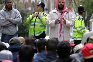 A muslim clergy man (C no name given) leads followers of radical muslim Sheikh Abu Hamza al-Masri outside the Finsbury Park mosque in
