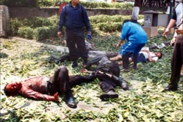 Injured men lay on the ground after a bomb blast in front of the Australian Embassy in Jakarta on September 9, 2004.
