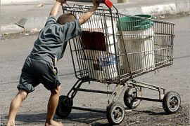 REUTERS - A Palestinian boy pushes a shopping trolley in the Jabalya refugee camp, northern Gaza Strip October 12, 2004.