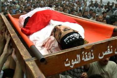 Mourners carry the body of a Palestinian militant Ali Darwesh, who was killed with his brother during an Israeli raid at the Jabalya refugee camp in northern Gaza Strip, October 6,2004