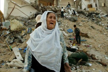 File photo of a Palestinian woman crying from the rubble of her home demolished by Israeli bulldozers,