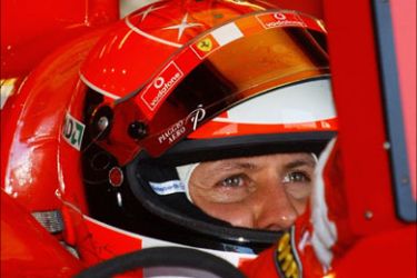 German F1 Ferrari driver Michael Schumacher watches a monitor in his car during the practice session at the 2004 United States Grand Prix, 19 June 2004 at Indianapolis Motor Speedway in Indianapolis, IN. The race will be run on 20 June. AFP PHOTO/Stan HONDA