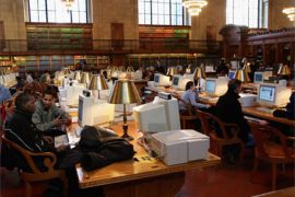 People work on computers in one of the reading rooms at the New York Public Library 15 December 2004 in New York City.