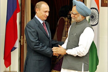 REUTERS/Indian Prime Minister Manmohan Singh (R) shakes hands with Russian President Vladimir Putin before the start of their