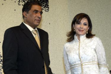 a/Egyptian film star Ahmed Zaki poses with Lebanese singer Magida al-Roumi during a reception held to mark the start of filming of a new movie based on the biography of the late Egyptian singer Abdel Halim Hafez, late 16 January 2005