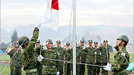 AFP- Japan's Self-Defence Force soldiers hoist their countrie's flag during a ceremony at their base camp in an area of the