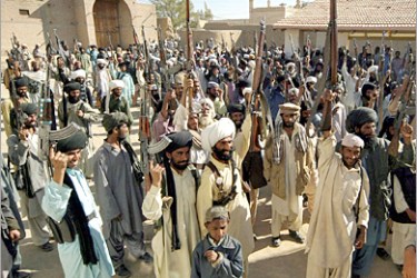 AFP - Pakistani Baluch tribesmen raise their weapons as they gather for a Jirga (Tribal Assembly) at Dera Bugti, in