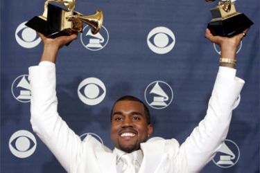 US rapper Kanye West holds his three Grammys aloft 13 February 2005 after the Grammy Awards ceremony in Los Angeles. West won for best rap album, best rap song and best R&B song.