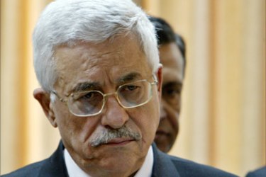 Palestinian President Mahmoud Abbas looks down during a press conference in the West Bank city of Ramallah, February 26, 2005.