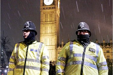 REUTERS /Snow falls over British police officers guarding the Houses of Parliament in London, February 21, 2005. Britons were warned on Monday to expect the coldest weather of the