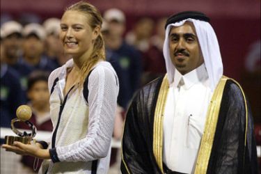 afp - Russian Maria Sharapova holds the trophy next to Sheikh Mohammed bin Faleh al-Thani, head of the Qatari Tennis Federation, after winning the WTA final against Australian Alicia Molik in Doha 26 February 2005. Sharapova won 4-6, 6-1, 6-4.
