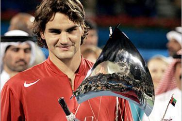 AFP - Swiss world number one Roger Federer holds his trophy after winning the ATP Dubai Men's Duty Free final against Ivan Ljubicic of Croatia, in Dubai 27 February 2005. Federer