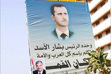 AFP - A giant portrait of Syrian President Bashar Assad with Arabic writing reading "President Bashar Assad was the only spokesman in the name of all the Arab nation during the Arab