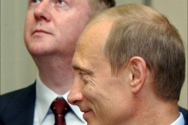 afp - A file picture taken 09 July 2003 shows Russian President Vladimir Putin (R) smiling, in front of the head of Russia's electricity monopoly, Anatoly Chubais during the opening ceremony