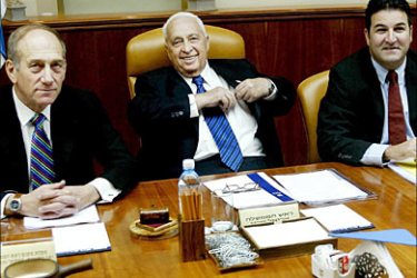 epa000414354 Israel Prime Minister Ariel Sharon, center, smiles as he sits with Vice Premier Ehud Olmert, left, and cabinet