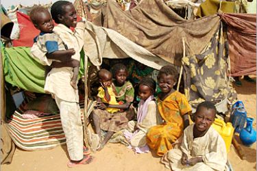 . AFP - Darfurian children, displaced by the two-year conflict in Sudan's shattered western province of Darfur, sit outside a tent in Abu Shouk which lies just outside el-Fasher, the
