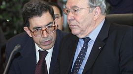 f_Tunisia's Foreign Minister Abdelbaki Hermassi (R) talks to an unidentified aide at the