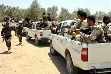 Iraqi border police officers begin a patrol near the Al-Sheiba oil refinery in the southern Iraq city of Basra, May 24, 2005.