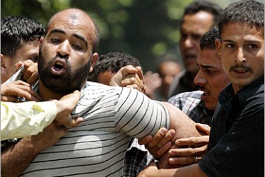 AFP - An Egyptian man, a supporter of the left-wing umbrella organization Kefaya (Enough), is arrested 25 May 2005 in Cairo for participating in a protest against the referendum