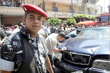 AFP - Lebanese internal security forces stand guard as explosives experts inspect the damaged car of Lebanon's former Communist Party chief George Hawi, who was assassinated