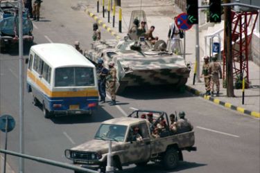 Yemeni army tank and military patrol take up positions on a street in the capital Sanaa July 22, 2005 as authorities expected violent protests for the third day on Friday. 11 people were killed and scores injured on Thursday during the second day of clashes between Yemeni security forces and rioters protesting fuel price increases. REUTERS/Khaled Abdullah