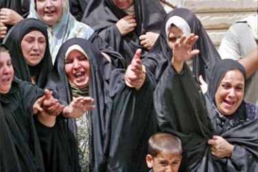 Women grieve at the funeral for a victim of a suicide car bomb attack in Baghdad July 13, 2005.