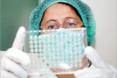 REUTERS/ Veterinary virologist Zamzamiya Pastukhova tests the blood of hens for bird flu virus at the central veterinary laboratory in the Siberian city of Krasnoyarsk August 6, 2005. Bird flu has