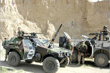 AFP - Italian (R) and French soldiers of the International Security Assistance Force (ISAF) patrol east of Kabul, 27 August 2005. ISAF troops in an area east of Kabul seized a large cache