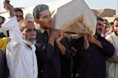 Mourners carry the coffin of a man who was killed during clashes with U.S. soldiers in Baghdad's Sadr City September 25, 2005. U.S. troops clashed with militia fighters loyal to rebellious Shi'ite cleric Moqtada al-Sadr in northwest Baghdad at around 2 a.m. (2200 GMT) leaving eight militiamen dead and several wounded, police said