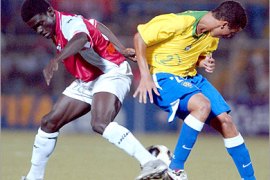epa00531979 Brazilian Reyrielton (R) vies for the ball with Mandou Bojang (L) of Gambia during the U17 World Cup soccer match held at the Miguel Grau Stadium in Piura,