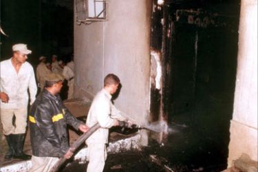 Egyptian firefighters spray water on a theatre in Beni Suef, about 100 km (62 miles) south of Cairo, September 5, 2005. A candle fell over and set fire to a crowded theatre in the south Egyptian town of Beni Suef on Monday night, killing 31 people and seriously burning 16 others, police and hospital sources said on Tuesday