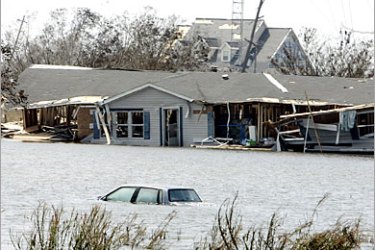 AFP / A house half immersed on highway 27 in the southwestern costal town of Creole, Louisiana, 26 September, 2005. Rescue helicopters scoured flooded areas of southern
