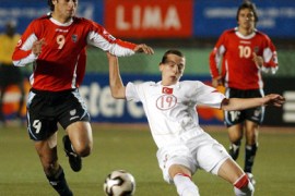 epa/Uruguay's Elias Figueroa (L) fights for the ball with Aykut Demir (R) from Turkey during the Peru FIFA's 2005 U17 World Cup soccer match held at National Stadium in Lima, Peru, Monday 19 of September 2005. EPA