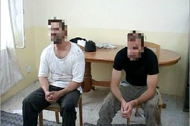 REUTERS/ A grab from footage released on September 20, 2005 shows two undercover British soldiers filmed by Iraqi police after their arrest in Basra, southern Iraq, September 19, 2005.