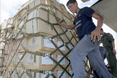 Thai air force officials load aid supplies sent by the Thai government to Pakistan which was hit by a devastating earthquake, at a military airport in Bangkok, 13 October 2005. Thailand has airlifted five million baht (122,000 dollars) worth of humanitarian aid for Pakistan's earthquake victims,