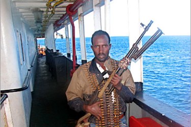 AFP / A Somali gunman carries a Russian-made long range machinegun in the port-town of Merca, 26 October 2005, 100 kilometers (65 miles) south of Mogadishu, as he guards