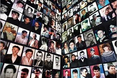 REUTERS /Portraits of Bosnian Muslims, victims of the 1995 Srebrenica massacre, are pasted on the wall in a room where survivors are gathering in the Bosnian town of Tuzla in this July 7, 2005