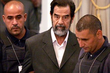 f_Saddam Hussein is led into court as his trial for crimes against humanity begins in Baghdad's