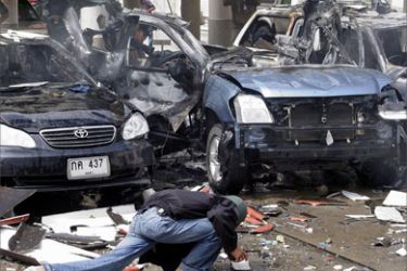 Thai forensic experts examine wreckage of an exploded car following a bomb blast in the parking area of a provincial government building in Thailand's violence raged southern Yala province, 08 November 2005.