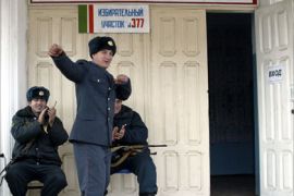 A Chechen policeman dances in front of a polling station on election day in Grozny November 27, 2005. Chechens were voting on Sunday for a regional assembly that is unlikely to appease anti-Moscow rebels but is expected to cement the power of a local pro-Russian strongman.