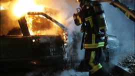 afp - Firemen work on a burned car in the suburbs of Strasbourg, eastern France, on the 15th night of unrest in French cities and suburbs 12 November 2005