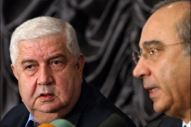 r - Syrian Deputy Foreign Minister Walid al-Moualem (L) and Riad al-Daoudi, the legal advisor of the Syrian Foreign Ministry, attend a news conference in Damascus November